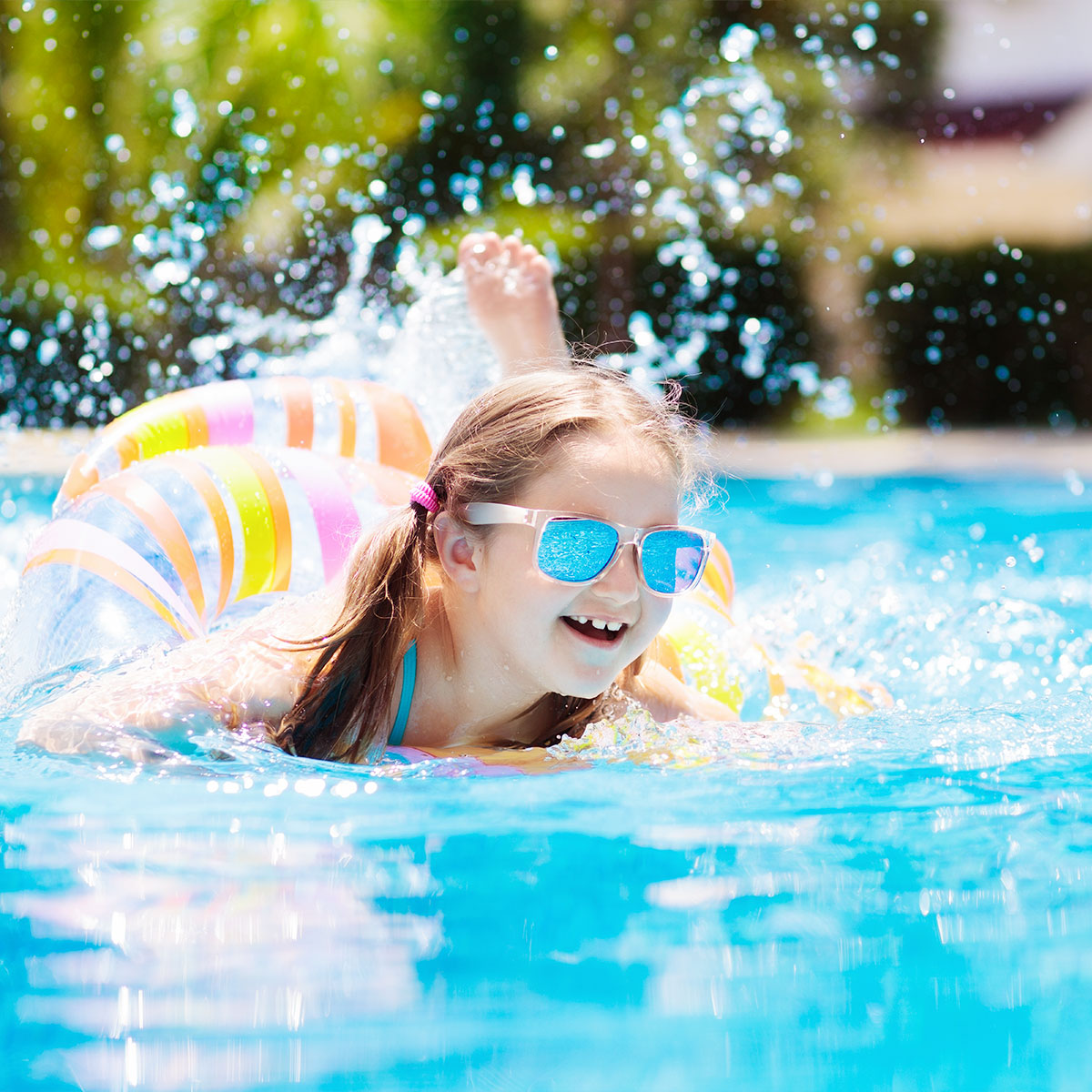 Little Girl Swimming Underwater In Pool